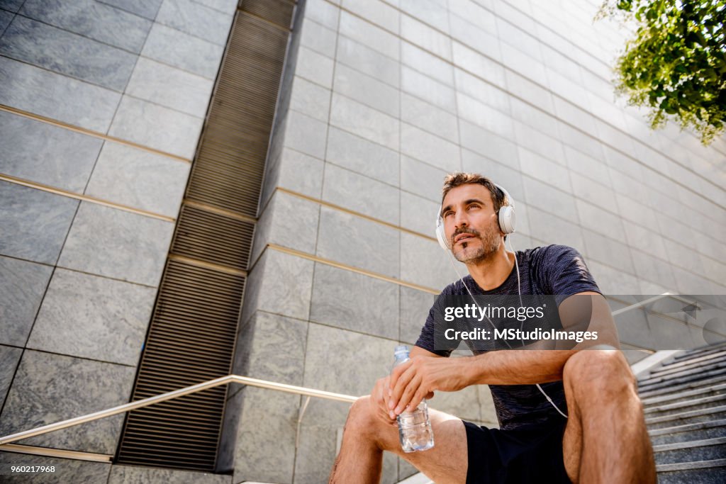 Mature sporty man taking a break.