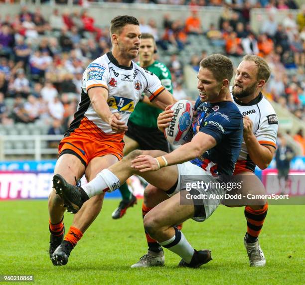 Leeds Rhinos' Matt Parcell is stopped short of the line by Castleford Tigers' Jv Hitchcox and Paul McShane during the Betfred Super League Round 15...