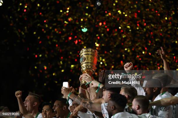 Players of Frankfurt lift the German DFB Cup trophy in the air and celebrate after the DFB Cup final between Bayern Muenchen and Eintracht Frankfurt...