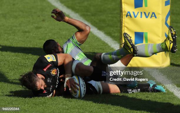 Don Armand of Exeter evades Vereniki Goneva to score their final try during the Aviva Premiership Semi Final between Exeter Chiefs and Newcastle...