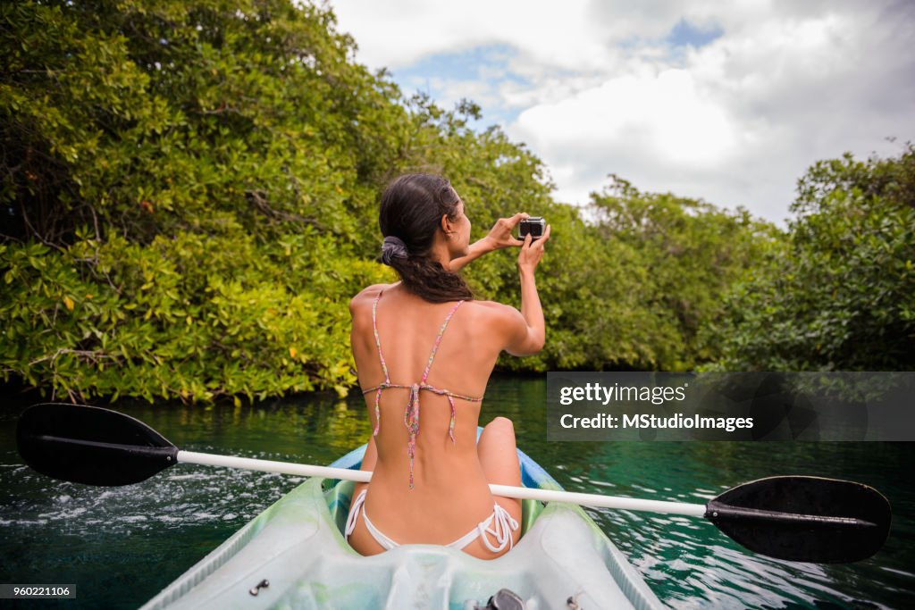 Woman in the kayak making a photo.