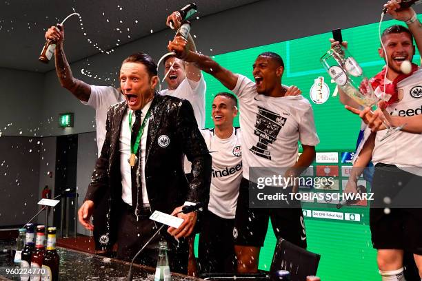 Frankfurt's Croatian head coach Niko Kovac reacts after his players soak him in beer at the press conference after the German Cup DFB Pokal final...