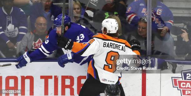 Fredrik Gauthier gets checked by Cole Bardreau as the Toronto Marlies play the Lehigh Valley Phantoms in the first game of the AHL Eastern Conference...