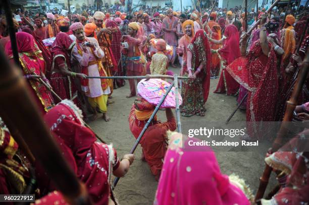 holi- festival of colours - lathmaar holi stock pictures, royalty-free photos & images