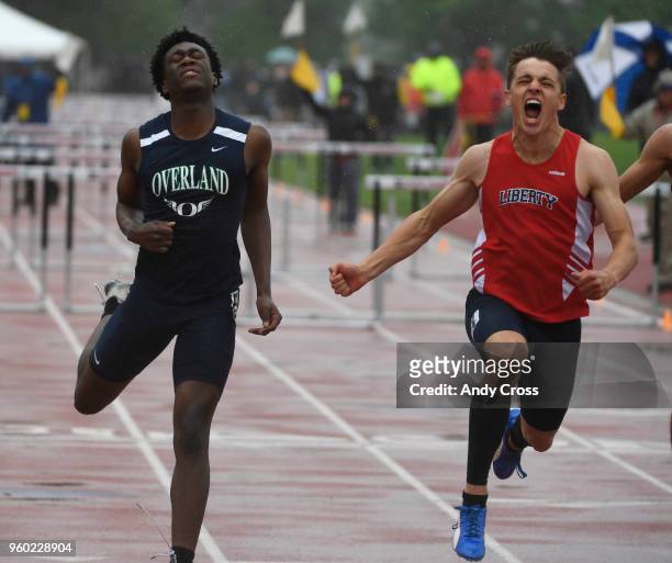 Andrew Doctor, Liberty, right, celebrates after crossing the finish line edging out Joel Nyatusah, left, Overland to win the 5A 110 meter hurdles...