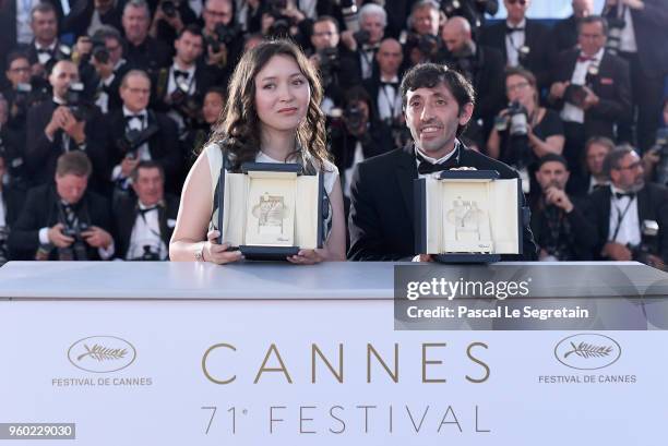 Actress Samal Yeslyamova poses with the Best Actress award for her role in 'Ayka' and actor Marcello Fonte poses with the Best Actor award for his...