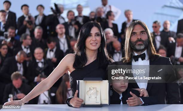 Lebanese director and actress Nadine Labaki , her husband Lebanese producer Khaled Mouzanar and Syrian actor Zain al-Rafeea pose with the trophy...