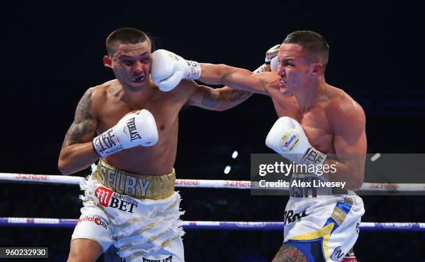 Josh Warrington lands a right shot on Lee Selby during IBF Featherweight Championship fight at Elland Road on May 19, 2018 in Leeds, England.