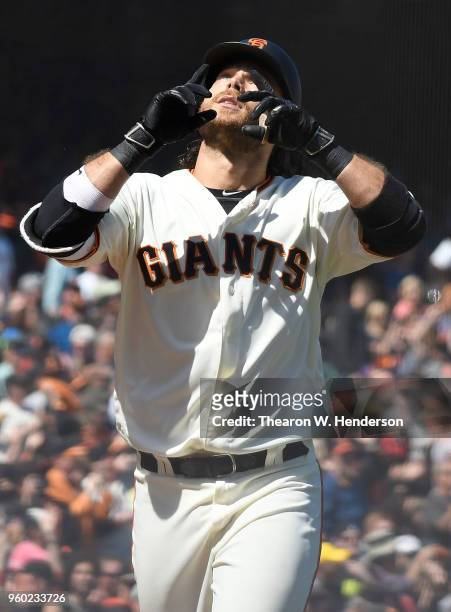 Brandon Crawford of the San Francisco Giants celebrates after he hit a two-run home run against the Colorado Rockies in the bottom of the six inning...