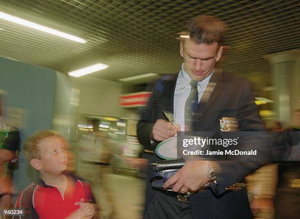 Tour Captain Martin Johnson signs an autograph for a young fan at Heathrow Airport prior to his departure on the British Lions tour of Australia. \...