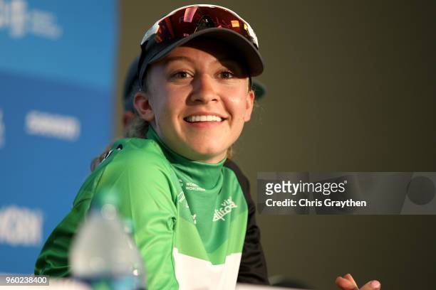 Emma White of the United States riding for Rally Cycling in the green Visit California Sprint leader jersey talks to the media during stage seven of...