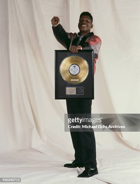 American rapper, record producer, and beatboxer, Doug E. Fresh with a gold disc award for sales of his 12-inch single, 'The Show', circa 1986.