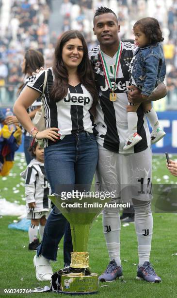 Alex Sandro of Juventus FC and family celebrates with the trophy after winning the Serie A Championship at the end of the serie A match between...