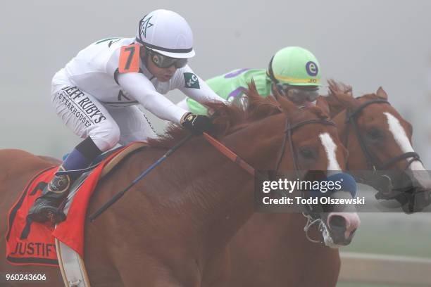 Justify ridden by jockey Mike Smith leads the field before winning the 143rd running of the Preakness Stakes at Pimlico Race Course on May 19, 2018...