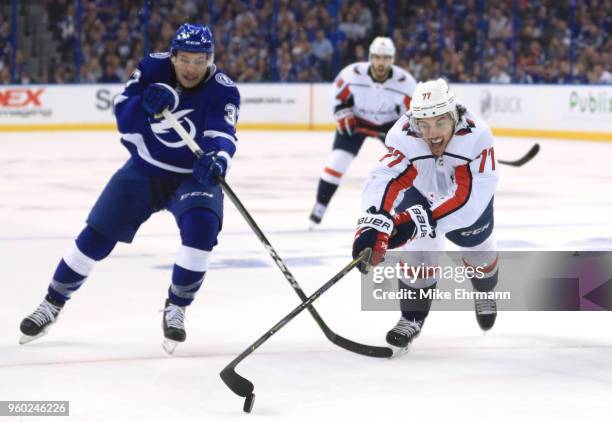 Oshie of the Washington Capitals skates for the puck against Yanni Gourde of the Tampa Bay Lightning during the first period in Game Five of the...