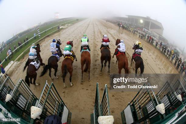 Justify ridden by jockey Mike Smith and the field come out of the starting gate during the 143rd running of the Preakness Stakes at Pimlico Race...