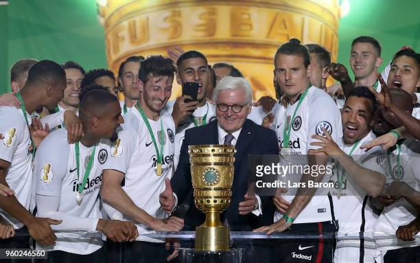 Federal President Frank-Walter Steinmeier hands over the trophy to team Captain David Abraham of Eintracht Frankfurt after winning the DFB Cup final...