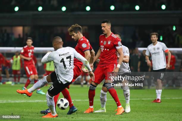 Javi Martinez of FC Bayern Muenchen is challenged by Kevin-Prince Boateng of Eintracht Frankfurt during the DFB Cup final between Bayern Muenchen and...