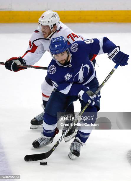 Tyler Johnson of the Tampa Bay Lightning skates with the puck against John Carlson of the Washington Capitals during the first period in Game Five of...
