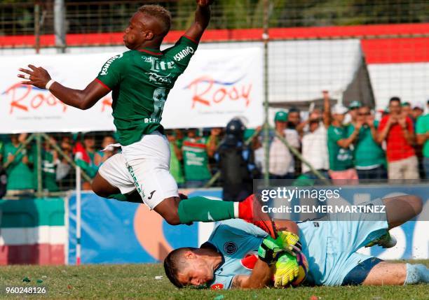 Marathon's Junio Lacayo and Motagua's goalie Jonathan Rougiervie for the ball during their Honduran Clausura Tournament football final at the Yankel...