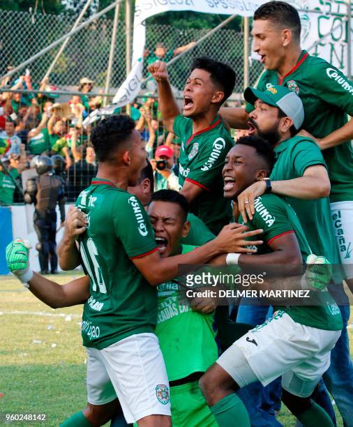 Marathon football players celebrate after defeating Motagua to win the Honduran Clausura Tournament at the Yankel Rosenthal stadium in San Pedro...