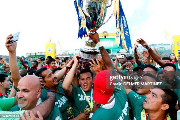 Marathon football players celebrate after defeating Motagua to win the Honduran Clausura Tournament at the Yankel Rosenthal stadium in San Pedro...