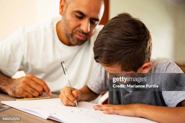 father and son working on homework - sydney school stock pictures, royalty-free photos & images