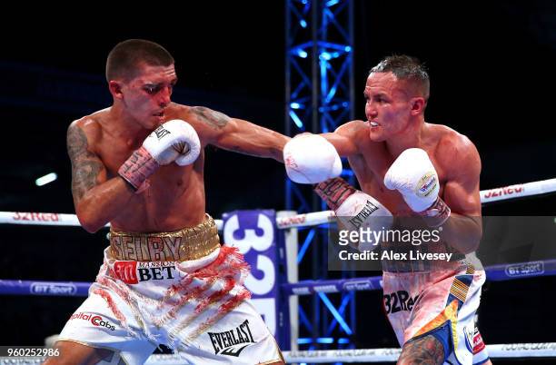 Josh Warrington throws a right shot at Lee Selby during IBF Featherweight Championship fight at Elland Road on May 19, 2018 in Leeds, England.