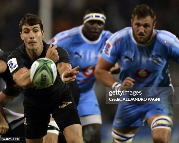 Argentina's Jaguares half scrum Gonzalo Bertranou passes the ball during their Super Rugby match against South Africa's Bulls at Jose Amalfitani...