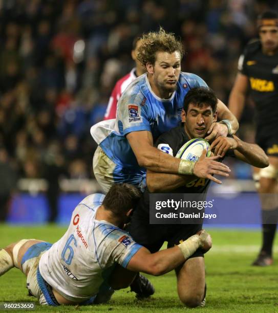 Matias Orlando of Jaguares is tackled by Rudolph Snyman of Bulls and Roelof Smit of Bulls during a match between Jaguares and Bulls as part of Super...