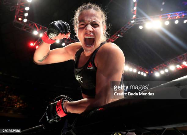 Poliana Botelho of Brazil celebrates after knocking out Syuri Kondo in their women's strawweight bout during the UFC Fight Night event at Movistar...