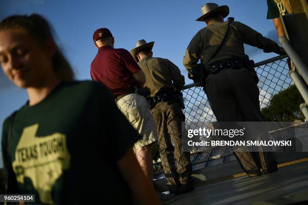 Texas State Troopers attend a Santa Fe HS baseball makeup game a day after the mass shooting May 19, 2018 in Deer Park, Texas. - Ten people, mostly...