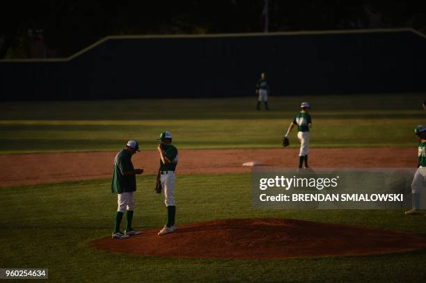 Players from the Santa Fe HS baseball team warm up on the field before a game in Deer Park, Texas on May 19, 2018. The game was to be played last...