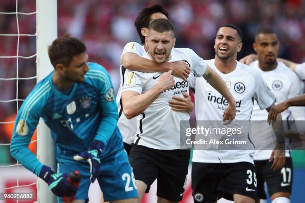 Goalkeeper Sven Ulreich of Muenchen reacts as Ante Rebic of Frankfurt celebrates his team's first goal with team mates during the DFB Cup final...