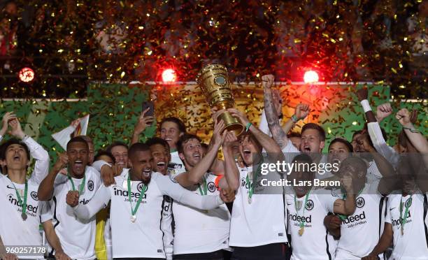 David Abraham and Alexander Meier of Frankfurt lift the trophy after winning the DFB Cup final between Bayern Muenchen and Eintracht Frankfurt at...