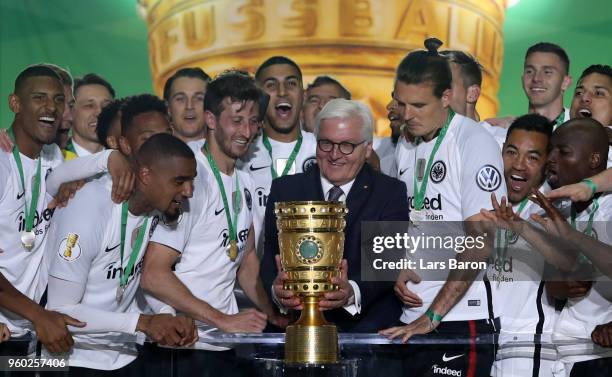 German President Federal President Frank-Walter Steinmeier hands over the trophy to team Captain David Abrahm and Alexander Meier during the DFB Cup...