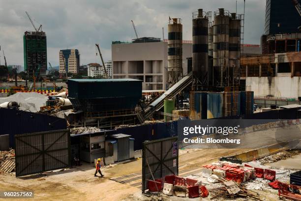 Worker enters a construction site in the Tun Razak Exchange financial district of Kuala Lumpur, Malaysia, on Saturday, May 19, 2018. Malaysian Prime...