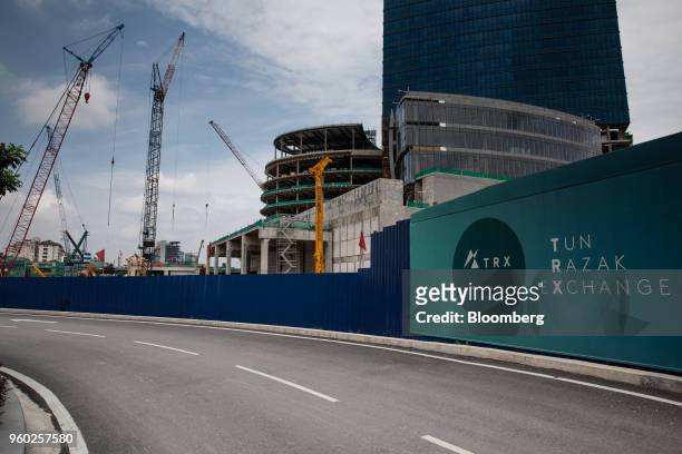 The Exchange 106, right, stands under construction next to cranes in the Tun Razak Exchange financial district of Kuala Lumpur, Malaysia, on...