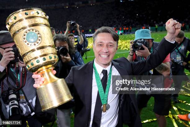 Head coach of Eintracht Frankfurt Niko Kovac lifts the DFB Cup trophy after winning the DFB Cup final against Bayern Muenchen at Olympiastadion on...