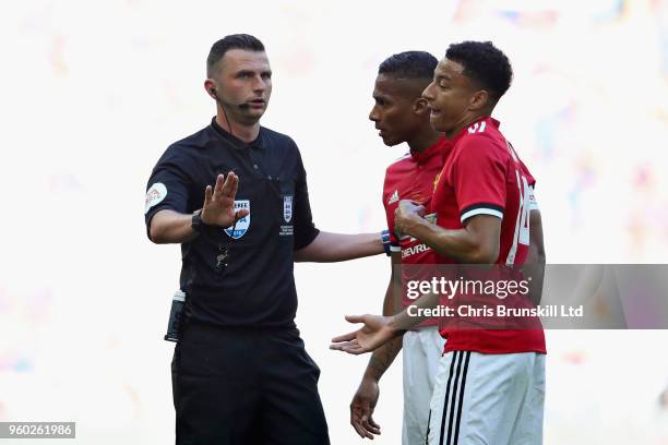 Referee Michael Oliver talks with Antonio Valencia and Jesse Lingard both of Manchester United during the Emirates FA Cup Final between Chelsea and...
