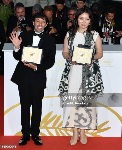 Actress Samal Yeslyamova poses with the Best Actress award for her role in 'Ayka' and actor Marcello Fonte poses with the Best Actor award for his...