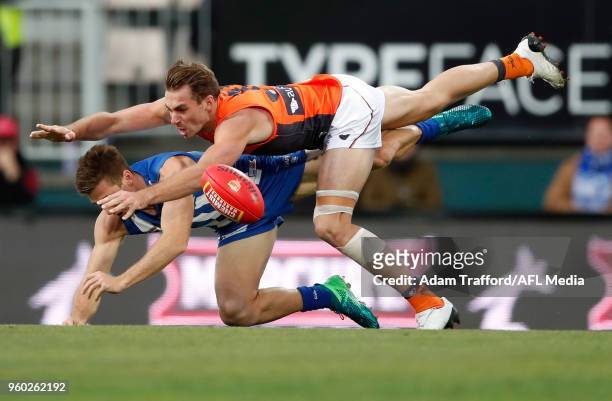 Jeremy Finlayson of the Giants and Shaun Atley of the Kangaroos compete for the ball during the 2018 AFL round nine match between the North Melbourne...