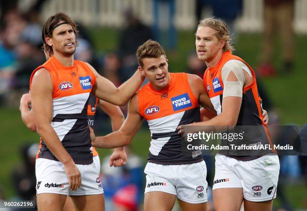 Zac Langdon of the Giants celebrates a goal with Ryan Griffen and Harry Himmelberg of the Giants during the 2018 AFL round nine match between the...