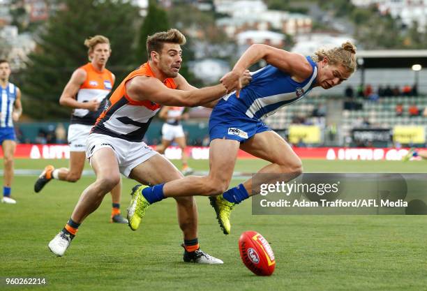 Jed Anderson of the Kangaroos is pushed off the ball by Stephen Coniglio of the Giants during the 2018 AFL round nine match between the North...