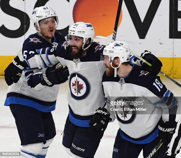 Jack Roslovic, Mathieu Perreault and Bryan Little of the Winnipeg Jets celebrate after teammate Tyler Myers scored a third-period goal against the...