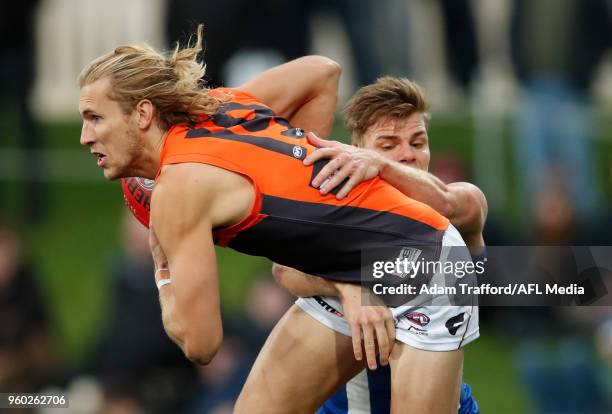 Nick Haynes of the Giants is tackled by Mason Wood of the Kangaroos during the 2018 AFL round nine match between the North Melbourne Kangaroos and...