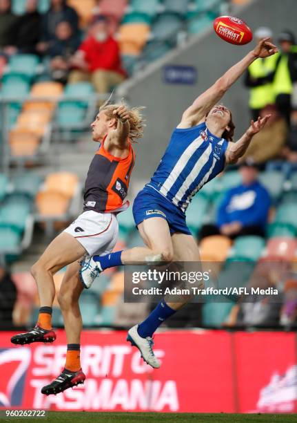 Ben Brown of the Kangaroos marks the ball ahead of Nick Haynes of the Giants during the 2018 AFL round nine match between the North Melbourne...