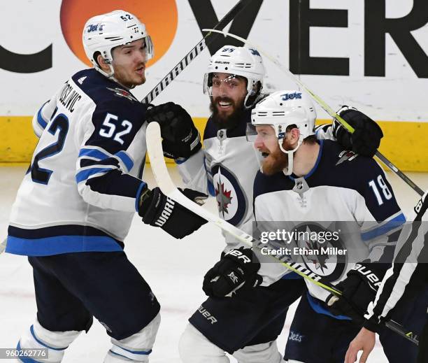 Jack Roslovic, Mathieu Perreault and Bryan Little of the Winnipeg Jets celebrate after teammate Tyler Myers scored a third-period goal against the...