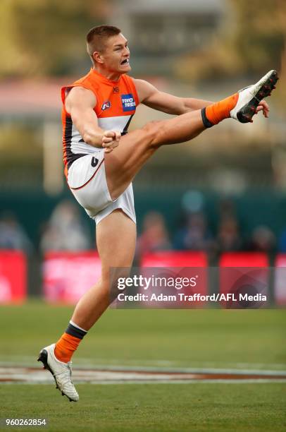 Adam Tomlinson of the Giants kicks the ball in his 100th game during the 2018 AFL round nine match between the North Melbourne Kangaroos and the GWS...