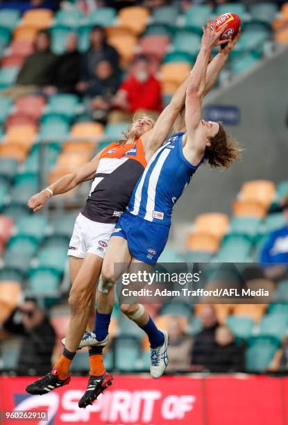 Ben Brown of the Kangaroos marks the ball ahead of Nick Haynes of the Giants during the 2018 AFL round nine match between the North Melbourne...